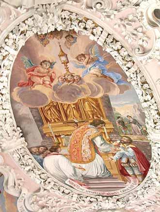 A painting depicting a priest at the altar with angels above, celebrating the Eucharist.
