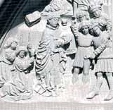 A relief depicting a religious scene with figures in historical attire.