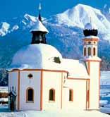 Church of St. Oswald in Seefeld, Austria, set against snowy mountains, linked to the 1384 Eucharistic miracle.