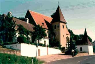 Weiten parish church, Austria, where the 1411 Eucharistic miracle occurred, featuring a red roof and prominent tower.