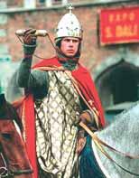 A knight in armor holding a relic, symbolizing the return of the Holy Blood.