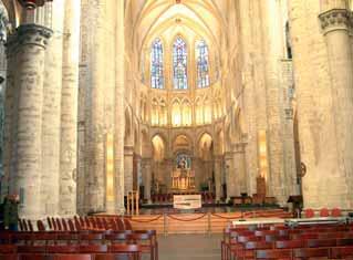 Interior view of the Cathedral of St. Gudula featuring its architectural details and altar.
