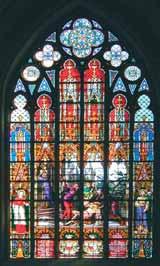 A stained glass window depicting the Eucharistic miracle with vibrant colors and detailed figures.
