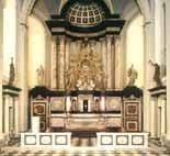 An ornate church altar with statues and a domed ceiling, featuring intricate architectural details.