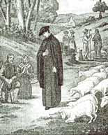 A priest stands among sheep with people in the background, depicting a pastoral scene.