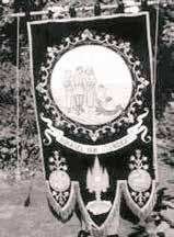 A decorative banner illustrating the discovery of the miraculous Host, featuring ornate designs and religious imagery.