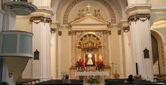 Interior view of a church with an altar and seating area.