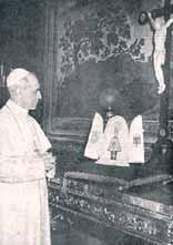 Pope Paul VI praying in front of a crucifix and altar.