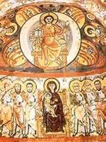 A religious fresco depicting Christ in glory surrounded by saints and the Virgin Mary.