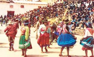 A group of people in traditional clothing dancing in a festive outdoor setting.