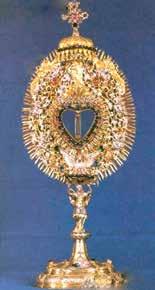 A golden monstrance designed to hold the Eucharistic host, elaborately decorated with jewels.