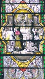 A stained-glass window illustrating the Eucharistic Miracle with figures in a church setting.