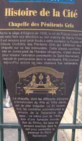 A plaque detailing the history of the Chapel of the Gray Penitents.