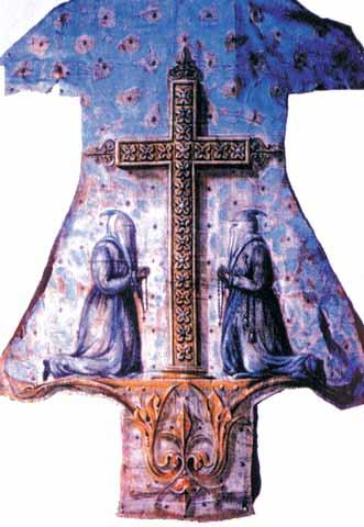 A decorated cassock featuring a cross and two figures in prayerful poses.