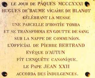 A plaque commemorating the Eucharistic Miracle of Blanot, detailing the event and its significance.