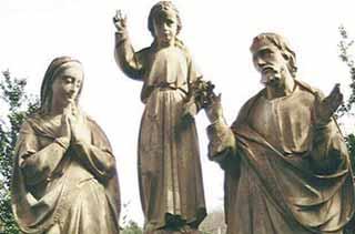Statues of the Holy Family with Jesus in the center, depicting a religious scene.