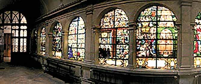 Interior view of stained glass windows in a chapel.