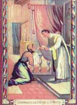 A priest administering communion to a kneeling woman in a hospital setting.