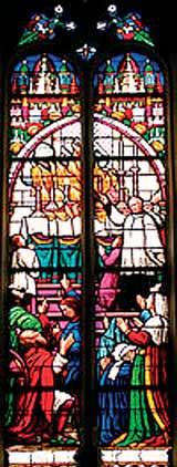 A stained glass window depicting a Eucharistic scene with figures in religious attire and worshippers.