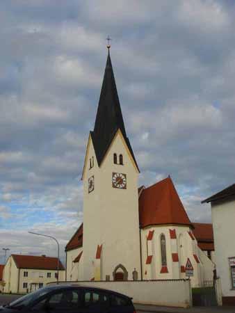 The church at Bettbrunn, with its tall spire and clock, marks the site of the 1125 Eucharistic miracle.