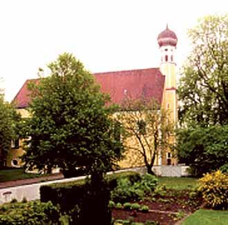 The Sanctuary of the Most Precious Blood, surrounded by lush gardens, commemorates the 1417 Eucharistic miracle in Erding.