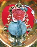 A religious relic featuring a red and blue design with ornate decorations.