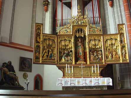 An ornate altar with multiple panels depicting religious scenes and figures.