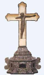 A decorative crucifix with a figure of Christ on a base, symbolizing the Eucharistic miracle.