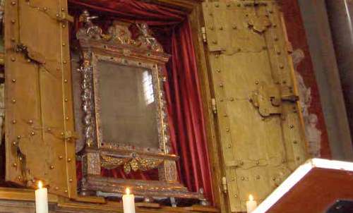 The relic of the miraculous corporal, framed and displayed, commemorates the 1330 Walldürn Eucharistic miracle of Christ's image.