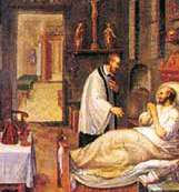 A priest administering communion to a bedridden person in a dimly lit room.