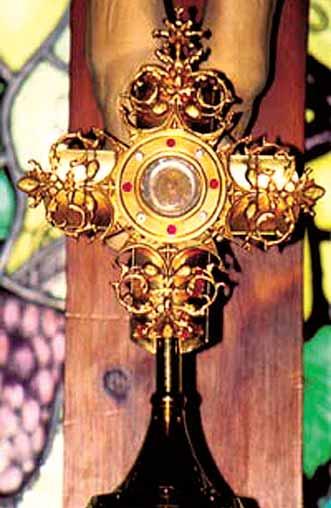 A golden reliquary cross containing a relic of the Precious Blood of Christ.