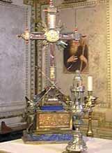 A decorative reliquary with a cross and ornate details, symbolizing the Precious Blood of Christ.
