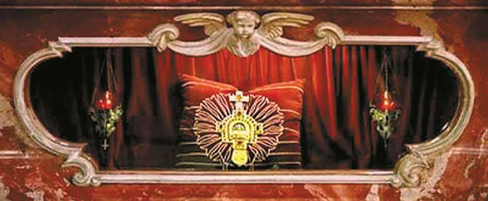 An ornate display of the sacred relic within a decorative frame.