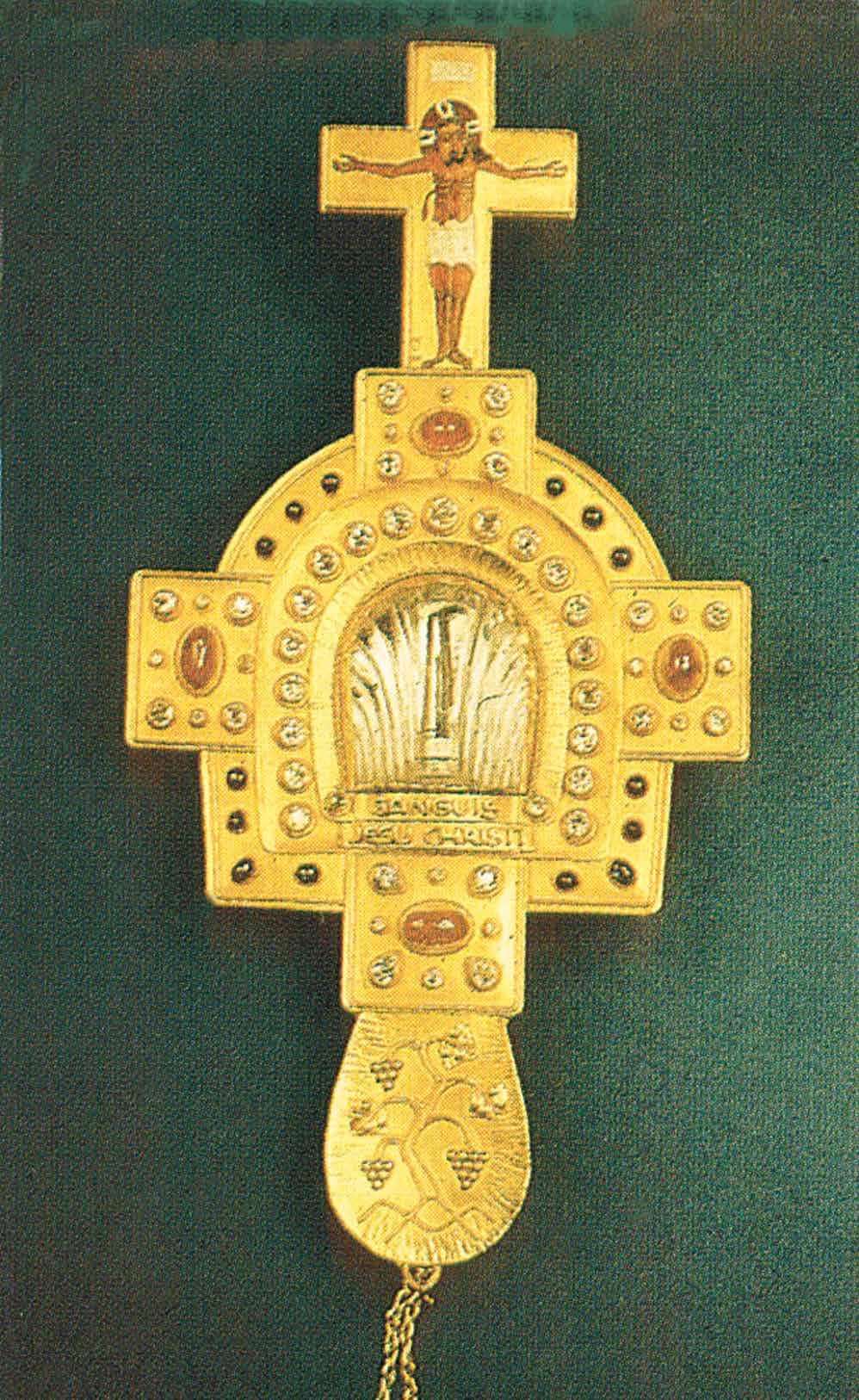 A golden cross relic containing a fragment associated with the Most Precious Blood of Jesus.