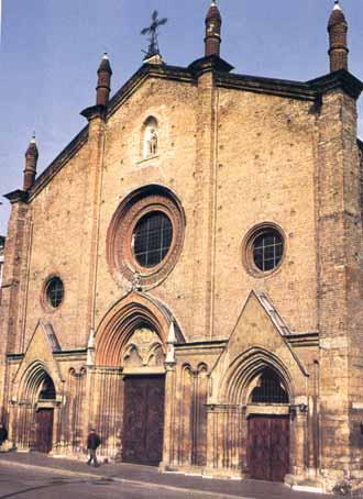 Exterior view of the Collegiate church of San Secondo, showcasing its architectural features.