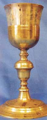 A golden chalice used in a Eucharistic miracle, showing blood stains inside.