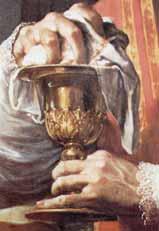 A close-up of a hand holding a chalice, possibly during a religious ceremony.