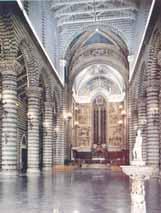Interior view of the Orvieto Cathedral showcasing its architectural design and lighting.