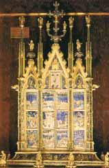 A golden reliquary with intricate designs and religious imagery.