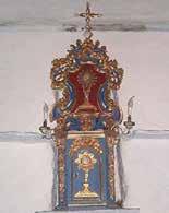 Ornate altar with monstrance, symbolizing Father Reinardi's Eucharistic blessing that saved Canosio from the 1630 Maira River flood.