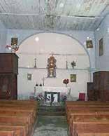 Interior view of a church showing the altar and seating arrangement.