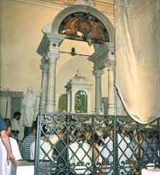 Interior view of the chapel housing the Holy Relics, showing worshippers and architectural details.