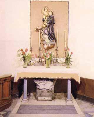 Altar constructed on the trunk of the column from which Saint Anthony performed the miracle, adorned with flowers and a statue.