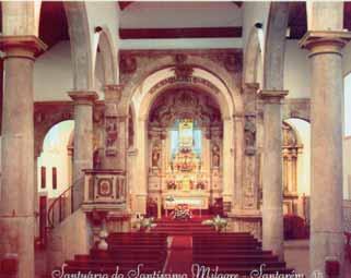 An interior view of a church shrine with ornate columns and an altar in the background.
