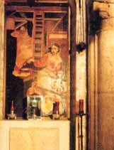 A fresco depicting a religious scene with a figure in a red robe and a ladder.