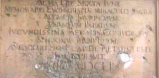 An inscription detailing the Eucharistic Miracle of Turin, with historical significance.