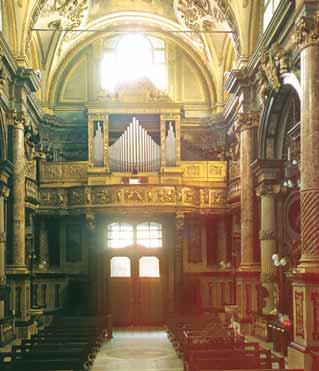 The ornate interior of Corpus Domini Basilica, Turin, where the 1453 Eucharistic miracle occurred, featuring its grand organ.