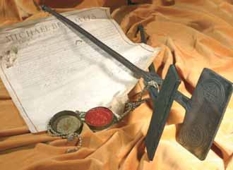 An iron object with seals and a document, likely related to the Eucharistic Miracle of Turin.