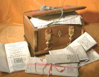 A wooden box with documents and scrolls related to the Eucharistic miracle.