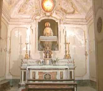An ornate chapel featuring a statue and altar, used for worship and remembrance of the miracle.